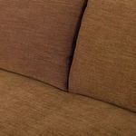 Angled view from floor highlighting Lynne Sofa’s rolled arm, seat cushions, and turned front legs with casters.