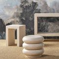 Styled setting showing Carson Ivory Terrazzo table with ambient lighting and artistic textured backdrop