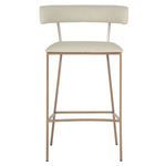 Full front view highlighting squared brass-finished metal legs and footrest