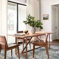 Heidi Ivory Ocean rug under light wood dining table with brown chairs in bright room