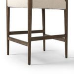 Lower frame and leg stretchers of toasted oak with fabric wrapped seat above