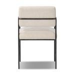 Rear view displaying the squared upholstered backset and black iron frame structure