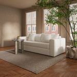 Angled side view of Kiran sleeper sofa showing armrest, cushions, and plush upholstery in room setting