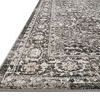 Close-up angled edge view showing detailed border and thin pile height of the Odette charcoal and silver rug