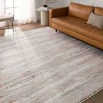 Rug styled in living room with caramel leather sofa, wooden side table, and natural light