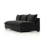 Side close-up view of sofa back pillow and seat cushion junction with fabric detail