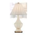 Musetta Table Lamp shown from a slight side angle with pleated fabric shade