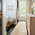 Chris Natural / Multi Rug shown as runner in narrow bathroom with window and wood cabinetry