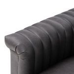 Close-up on leather surface showing fine grain pattern and matte finish in dark gray