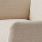 Detail of armrest corner showing fine linen blend texture and rounded edges