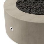 Close-up showing textured concrete surface and a small round metal control panel on fire table side