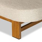 Corner close-up showing smooth upholstery and wooden sofa leg detail