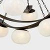 Close-up of textured seedy glass shades and curved metal bands with visible light inside