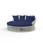 Curved silver-grey rope frame Miami Daybed with round navy blue cushion and multiple blue throw pillows