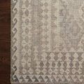 Detailed close-up showing rug texture on dark hardwood floor, emphasizing color variation and weave