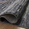 Close-up of plush texture and folded edge of Soho Onyx Silver Rug on wood floor