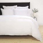 Langston Bamboo Sateen Euro Sham styled on bed with multiple white pillows and neutral room decor