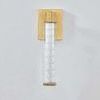 Castor Bath Sconce seen from above showing rectangular aged brass backplate and glass tube top