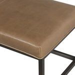 Overhead close-up focusing on corner of taupe leather cushion with smooth finish