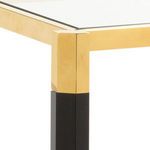 Close-up of the gold and black corner joint and glass top of the Boulevardier Bar Cart