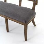 Close-up of bench corner seat upholstery and angled wood leg detail