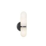 Salon sconce illuminated, showing warm ambient glow from alabaster globes