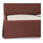 Slatted bed base lifted showing storage space inside bed frame upholstered in rust fabric