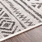 Corner close-up highlighting flat weave texture and pile-less construction