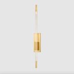 Close-up of Rosco Wall Sconce with warm light glowing through dual-layer acrylic rod and brass fixture