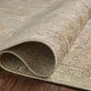 Rolled corner detail displays flexible weave and pile height on hardwood floor of beige patterned rug