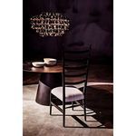 Close-up side angle with chair and bowls on table under warm hanging chandelier