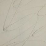 Extreme close-up of fine, curved pencil lines on textured cream background