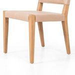 Close-up of Villa Dining Chair front left leg and leather seat corner with wood grain detail