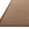 Close-up angled side view showing the rug’s textured weave and edge binding