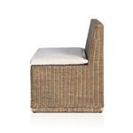 Side view highlighting cushion edge and woven rattan seat structure