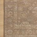 Close-up of the Louisa rug’s detailed pattern and edge on a natural wood floor