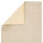 Close-up of turned corner with beige fabric backing folded back on Naples natural fiber rug