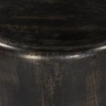 Close-up of rounded edge and textured bronze surface on end table top and side