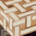 Close-up on basket-weave pattern showing woodgrain and smooth ivory composite on box corner