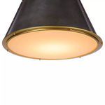 Close-up view of diffuser and natural brass ring showing warm glowing light beneath the shade