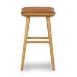 Back view of stool highlighting seat curvature and frame with footrest bars