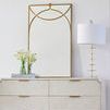 Gianna Gold Table Lamp styled on a dresser beside a gold-framed mirror and flower vase in a room setting