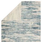 Heaston Rug flipped corner revealing muted ivory and gray backing with subtle vertical stripe design