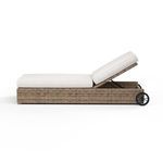 Side profile of Havana chaise with backrest reclined further and black wheels visible