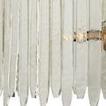 Front view focusing on arrangement of long vertical textured glass pieces secured to brass frame