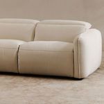 Angled living room view of sofa displaying plush cushions and textured fabric