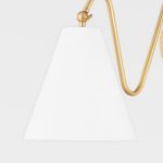 Close-up of the gold arm and white lampshade attachment with adjustment joint