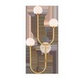 Highsmith Wall Sconce with three milk glass globes on curved brass stems and a round travertine wall plate