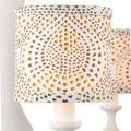 Detailed close-up showing spiral dot pattern in gold and brown on cylindrical fabric lampshade