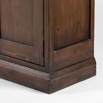 Close-up on lower corner with aged wood finish and distressed textured molding